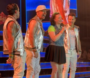 Teenage dream: Leslie Morris sings on stage with iconic boy band